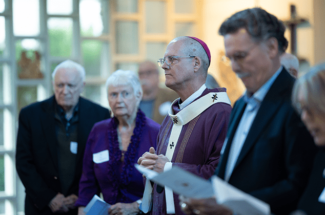 Archbisoph Etienne and others praying at the 2024 Crozier Lenten Retreat