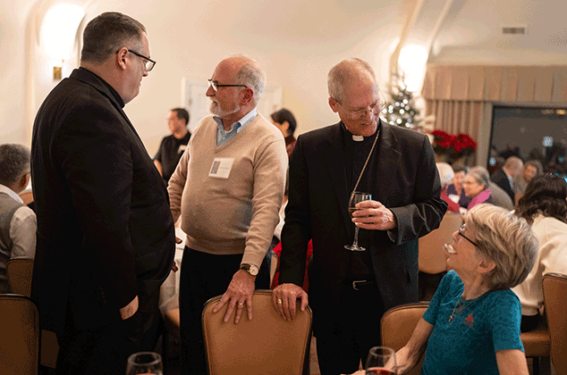 Archbishop Etienne and Bishop Schuster talking to people