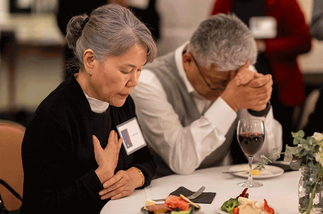 People praying before eating