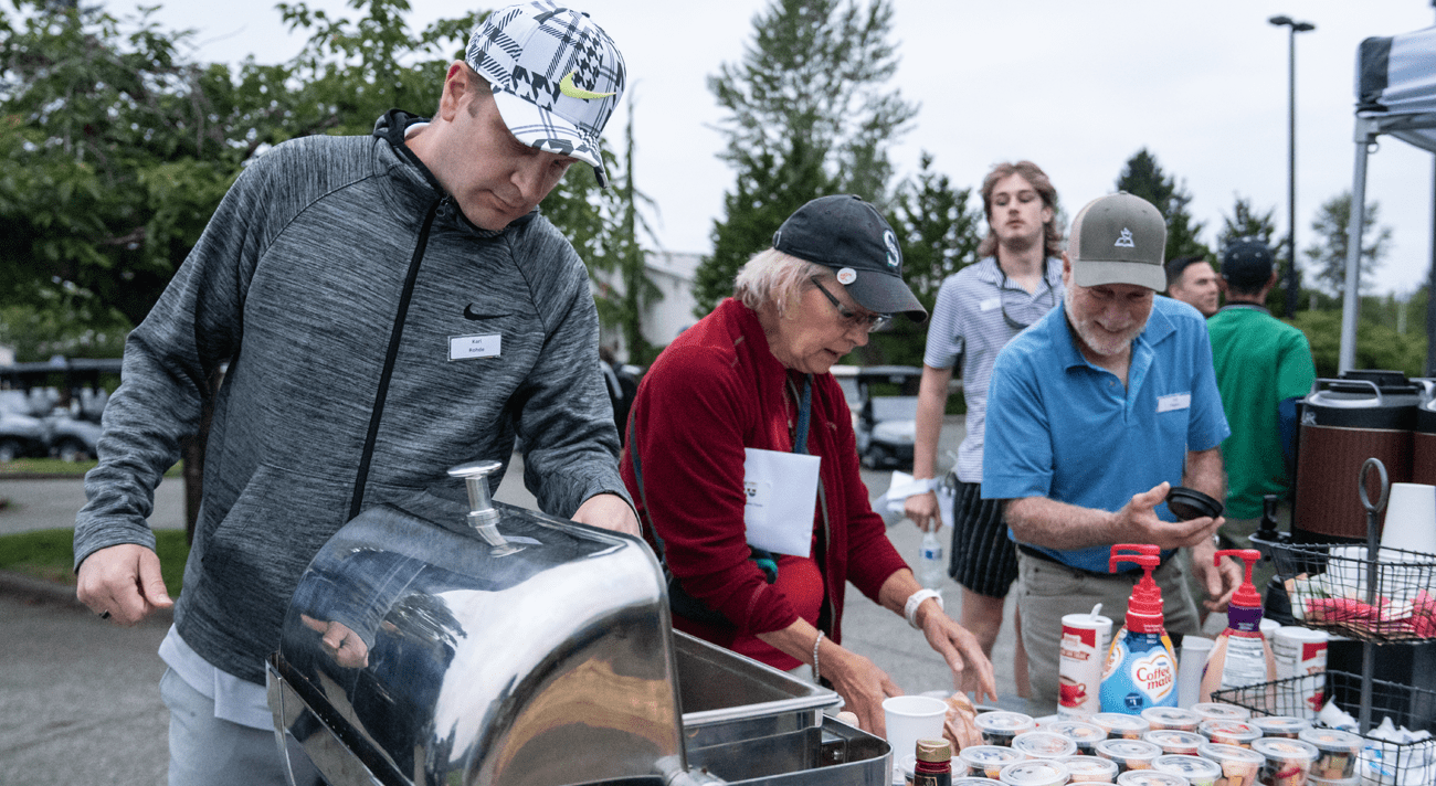 People eating food at a golf course