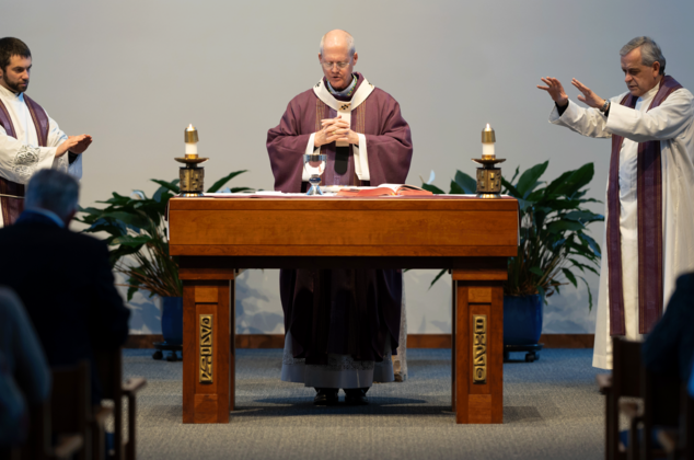 Archbishop Etienne and others praying at the 2024 Crozier Lenten Retreat